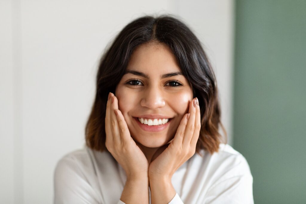 Smiling woman happy with her cosmetic dentistry results at All Smile Care