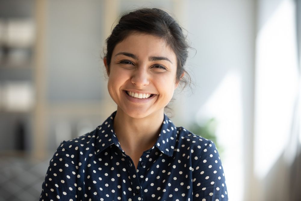 Smiling woman showing off her new porcelain veneers