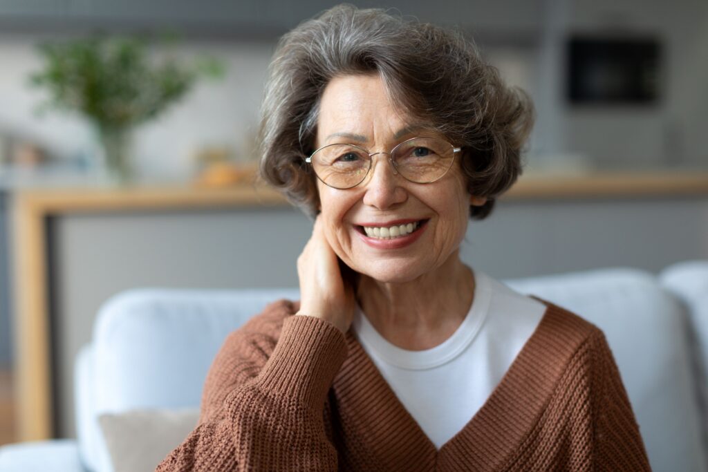 Smiling senior woman wearing snap-in dentures