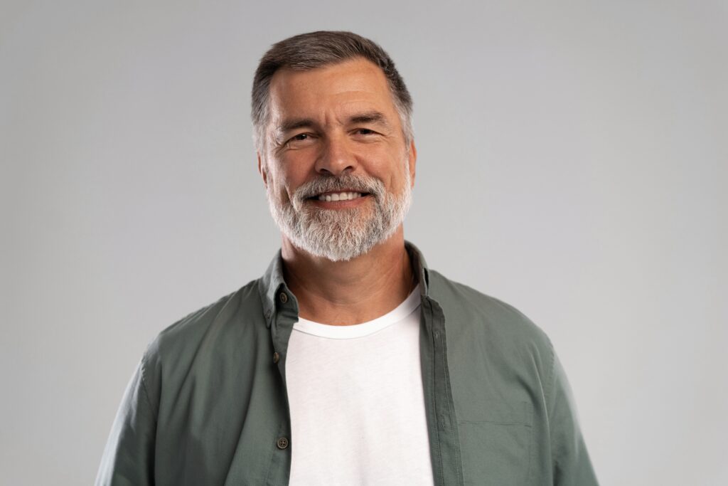 Smiling man after same-day emergency crown repair at All Smile Care in Lowell, MA