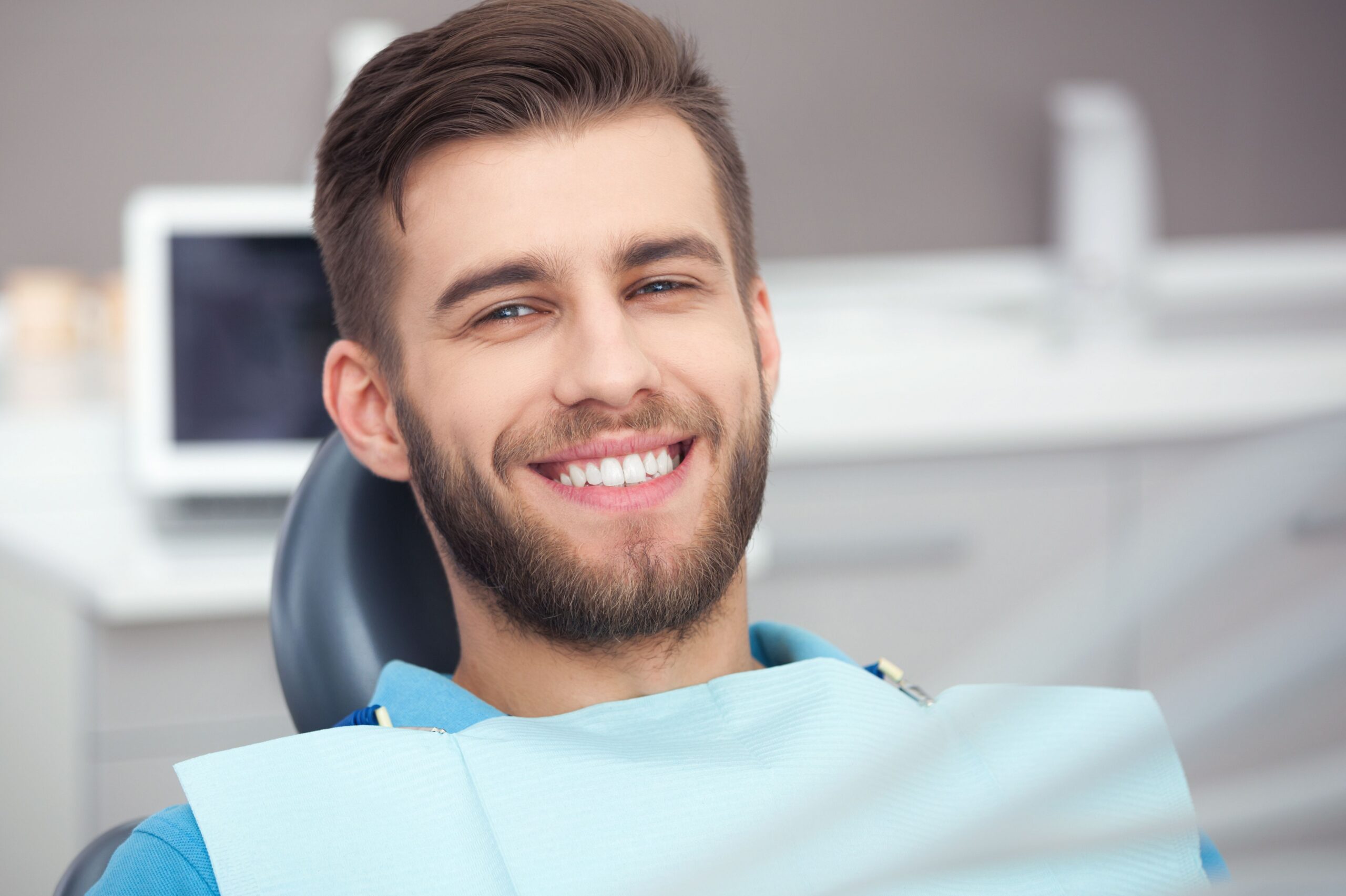 Young man in a dental chair after receiving a same-day crown