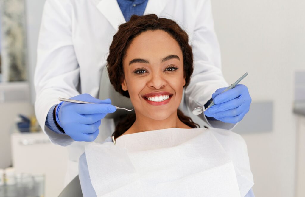 Dentist repairing a patient's lost filling at All Smile Care