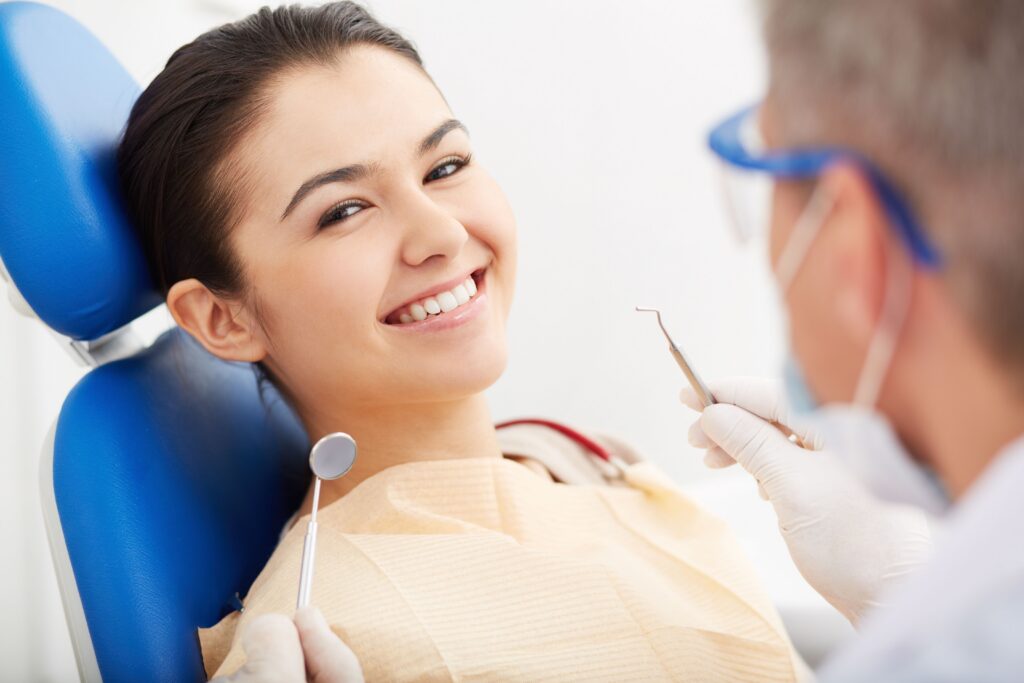 Dentist performing a crown lengthening procedure on a patient at All Smile Care