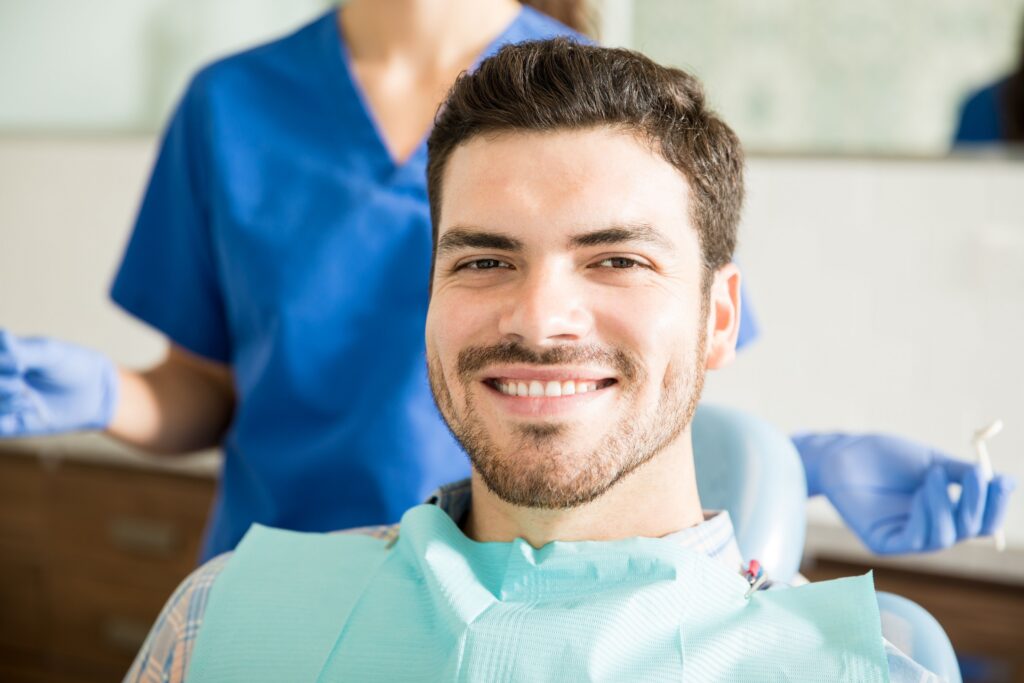 Patient in a dental chair during a comprehensive dental exam at All Smile Care