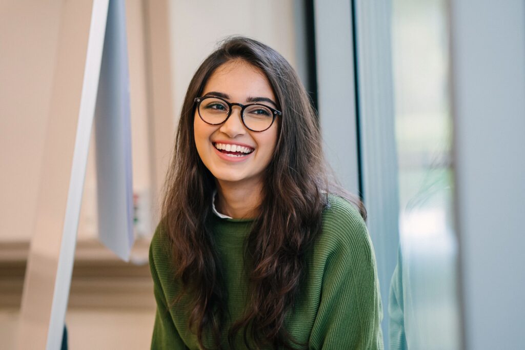 Young woman smiling after a tooth-colored filling at All Smile Care