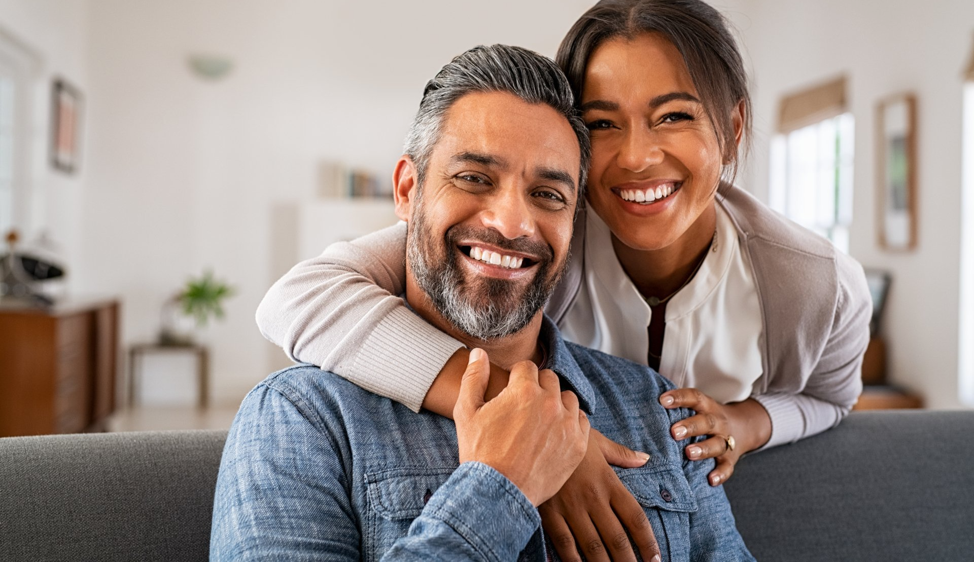 Happy couple smiling with confident, healthy smiles